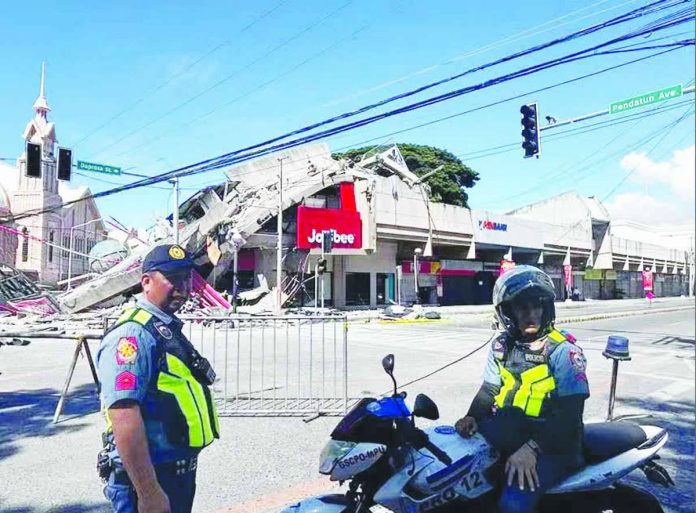PBBM_orders_copy_compressed_resized Policemen gather in front of a collapsed fast food restaurant after an 7.8 magnitude earthquake in General Santos City on June 8, 2026. Authorities continue to assess the impact of the earthquake, while residents have been advised to remain alert for possible aftershocks and comply with instructions from disaster management officials. AFP