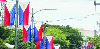 Philippine flags line a road in Cavite province. From May 28 to June 12, the Philippines celebrate National Flag Days, with homes, offices, and other establishments encouraged to display the Philippine flag to commemorate the day it was first unfurled in 1898. PNA