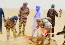 Nearly 50 people die of thirst in Sahara desert People, including several in military-style uniforms, use shovels to dig in a sandy desert area, with dust rising around them. AGADEZ GOVERNORATE/FACEBOOK