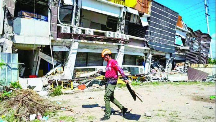 A responder prepares to take part in search and rescue operations outside a collapsed building in General Santos City on June 9, 2026. AFP