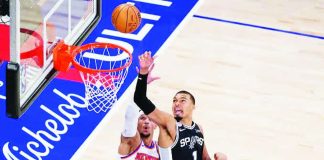San Antonio Spurs center Victor Wembanyama tries to reach the ball despite being held on by New York Knicks’ Karl-Anthony Towns. AP