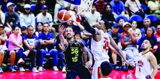 TNT Tropang 5G’s Jordan Heading goes for a tough shot against the defense of Barangay Ginebra San Miguel Kings' Justin Brownlee. PBA PHOTO
