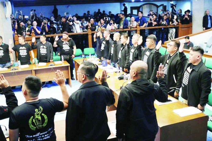 Tulfo_copy_compressed_resized Individuals identifying themselves as former Philippine Marines take their oath at the start of the Senate’s blue ribbon committee hearing on June 4, 2026.