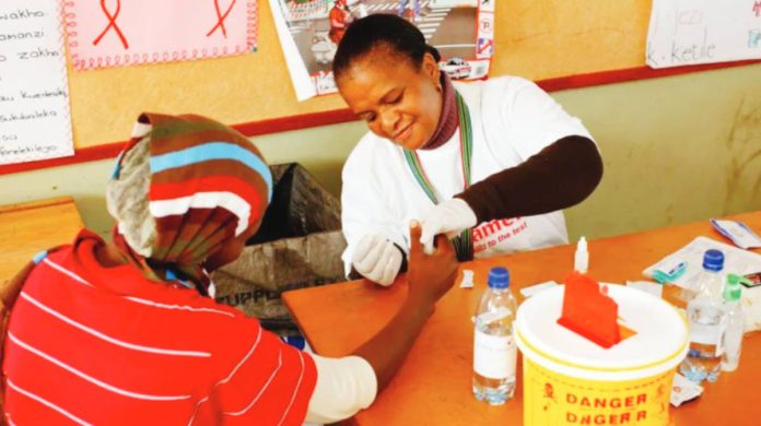 US A South African woman is testing another person for human immunodeficiency virus at a clinic. GETTY IMAGES