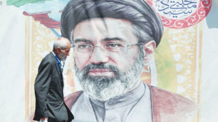 US Iran An Iranian man walks past a poster of Supreme Leader Mojtaba Khamenei in Tehran. EPA