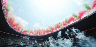 Fireworks display in the colors of the Mexican flag light up the edge of the open stadium roof during the World Cup opening ceremony. A massive golden mock World Cup trophy is on the pitch. GETTY IMAGES