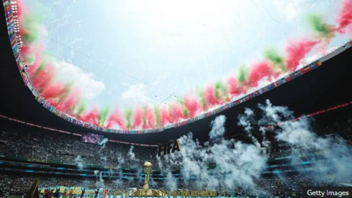 World Cup Fireworks display in the colors of the Mexican flag light up the edge of the open stadium roof during the World Cup opening ceremony. A massive golden mock World Cup trophy is on the pitch. GETTY IMAGES