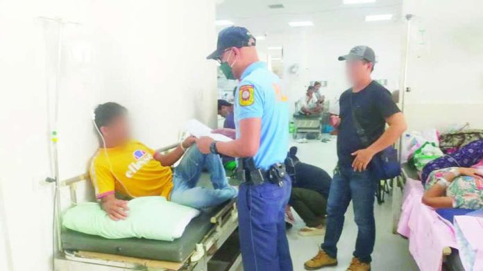 Police arrested alias “Ariel” (left) through the strength of an arrest warrant for qualified rape while confined at Dr. Rafael S. Tumbokon Memorial Hospital in Kalibo, Aklan at 3:20 p.m. on June 18, 2026. AKLAN PPO PHOTO