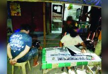 Police operatives inventory the suspected shabu and a caliber .45 pistol recovered from alias “Chad” (left), who was caught on June 8 in Barangay Rizal Lapuz Sur, Lapuz, Iloilo City. ICPO PHOTO