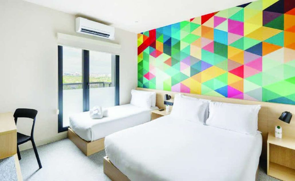 Hotel101’s signature 21-square meter HappyRoom is equipped with a practical kitchenette featuring microwave, refrigerator and kettle, luggage rack, 55” TV, free high-speed internet, work desk, modern bidet toilet, strong water pressure, and premium Emma Sleep mattresses.
