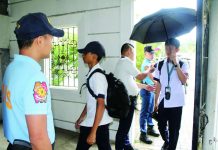 SCHOOLS TO STEP UP ANTI-BULLYING DRIVE; DepEd-6 moves to protect nearly 1M learners; Police visibility, bag inspections also pushed Police officers from Iloilo City Police Station 2 assist a campus security guard in inspecting the bags and belongings of students and visitors before entering the premises of Iloilo National High School in La Paz district on Tuesday, June 23. Beyond physical security measures, the Department of Education Region 6 says they are placing renewed focus on addressing bullying, which school authorities believe must be tackled proactively to prevent conflicts among learners from escalating. AJ PALCULLO/PN