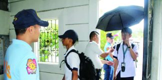 Police officers from Iloilo City Police Station 2 assist a campus security guard in inspecting the bags and belongings of students and visitors before entering the premises of Iloilo National High School in La Paz district on Tuesday, June 23. Beyond physical security measures, the Department of Education Region 6 says they are placing renewed focus on addressing bullying, which school authorities believe must be tackled proactively to prevent conflicts among learners from escalating. AJ PALCULLO/PN