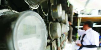 The International Energy Agency says low-income households consume only about half as much energy as high-income households and one-third less than median-income households. Photo shows a lineman checking the electric meter in Manila. PHOTO COURTESY OF TEMPO