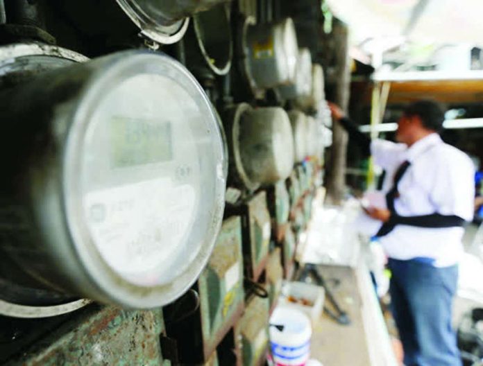 high_energy_compressed_resized The International Energy Agency says low-income households consume only about half as much energy as high-income households and one-third less than median-income households. Photo shows a lineman checking the electric meter in Manila. PHOTO COURTESY OF TEMPO