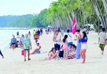 The Department of Tourism Region 6 warns tourists planning to visit the region to stay vigilant against unverified and online travel and tours agencies offering suspiciously cheap or ‘too good to be true’ travel packages. Photo shows tourists enjoying the sun and sand at Station 2 on Boracay Island in Malay, Aklan. RELAKS KALANG CH/FACEBOOK PHOTO