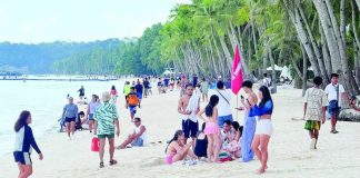 The Department of Tourism Region 6 warns tourists planning to visit the region to stay vigilant against unverified and online travel and tours agencies offering suspiciously cheap or ‘too good to be true’ travel packages. Photo shows tourists enjoying the sun and sand at Station 2 on Boracay Island in Malay, Aklan. RELAKS KALANG CH/FACEBOOK PHOTO