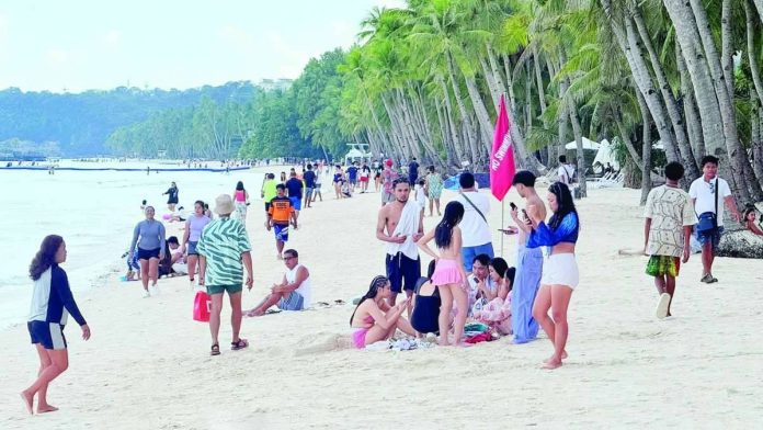 The Department of Tourism Region 6 warns tourists planning to visit the region to stay vigilant against unverified and online travel and tours agencies offering suspiciously cheap or ‘too good to be true’ travel packages. Photo shows tourists enjoying the sun and sand at Station 2 on Boracay Island in Malay, Aklan. RELAKS KALANG CH/FACEBOOK PHOTO