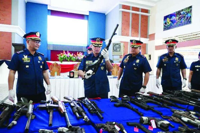 mai_guns1_copy_compressed_resized Police Regional Office 6 director Brigadier General Randulf Tuaño presents some of the 3,683 voluntarily surrendered firearms collected across Western Visayas since 2019 during a display in Iloilo City on June 29. Police said the campaign aims to prevent crimes by taking loose, unregistered firearms out of circulation before they can be used in criminal activities. PRO-6