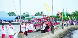 Parishioners, altar servers and cultural performers take part in the traditional traslación along the coastal promenade of Banate, Iloilo on June 23, 2026, as part of the annual “Biray” celebration honoring Saint John the Baptist. The centuries-old religious tradition combines a fluvial procession, prayers and a pilgrimage to the town’s former center. ARCHDIOCESE OF JARO COMMISSION ON SOCIAL COMMUNICATIONS