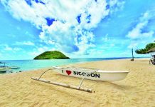 CARLES FIGHTS TO KEEP SICOGON TOURISM ALIVE; Assistance to displaced workers, new tourism programs readied A boat rests on the shores of Buaya Beach, a famous tourist spot in Barangay Buaya on Sicogon Island, Carles, Iloilo. The Carles municipal government assured the public that the island's famed white-sand beaches and natural landscape remain intact and open to both local and foreign tourists, despite the closure of luxury accommodations and villas operated by the Sicogon Island Tourism Estate Corporation. DISCOVER POTOTAN/FACEBOOK PHOTO