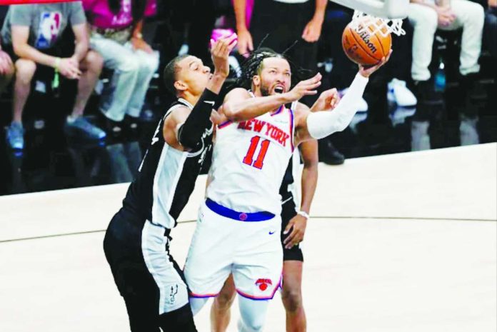 sports_NBA_Game1_compressed_resized New York Knicks guard Jalen Brunson goes for a tough shot while being defended by San Antonio Spurs center Victor Wembanyama. YAHOO SPORTS PHOTO