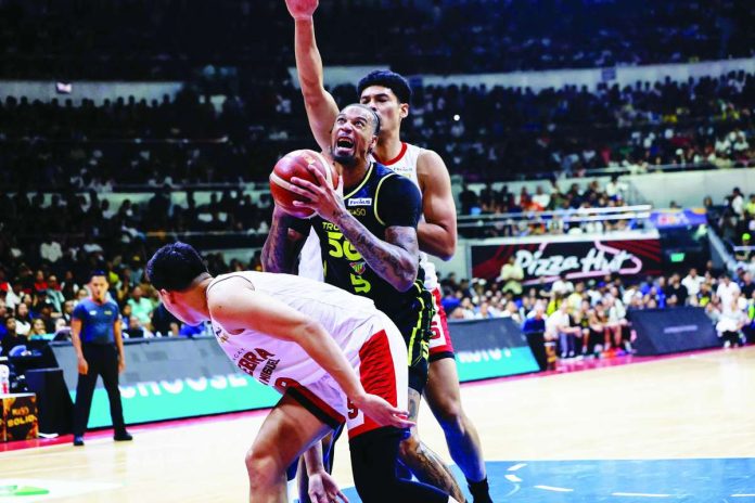 sports_PBA_compressed_resized TNT Tropang 5G’s Chris McCullough tries to score against the defense of Barangay Ginebra San Miguel Kings’ Japeth Aguilar. PBA PHOTO