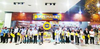Stakeholders from SM Savemart and Vista Mall, alongside guests, lead the ceremonial ribbon-cutting to mark the official opening of Savemart at Vista Mall Iloilo.