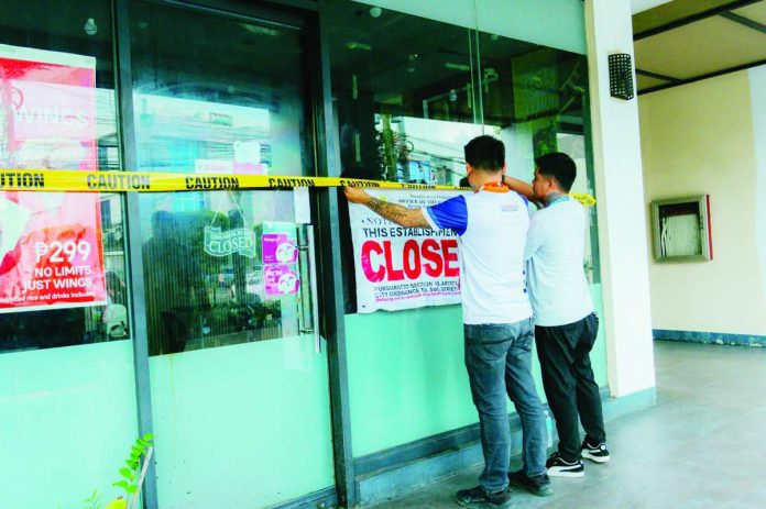 Bacolod_businesses_compressed_resized Personnel of the Bacolod City Legal Office (CLO) Enforcement Team served closure orders and padlock business establishments in Barangay Villamonte on July 16 after they were found operating without the required business permits. The operation formed part of the city government's intensified campaign to enforce compliance with local licensing regulations. BCCO PHOTO