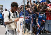 Cape Verde football team captain Ryan Mendes sign shirts for fans. BBC