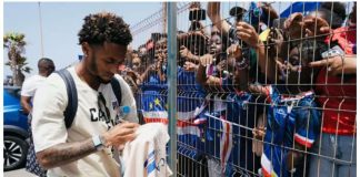 Cape Verde football team captain Ryan Mendes sign shirts for fans. BBC