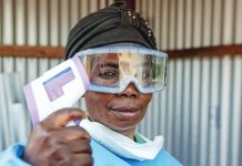 Congo bans mass gatherings to prevent spread of Ebola A healthcare worker wears goggles and a mask pulled down from her mouth, and holds up a thermometer. Ebola has been confirmed in three provinces of Congo so far – Ituri, North Kivu and South Kivu. GETTY IMAGES