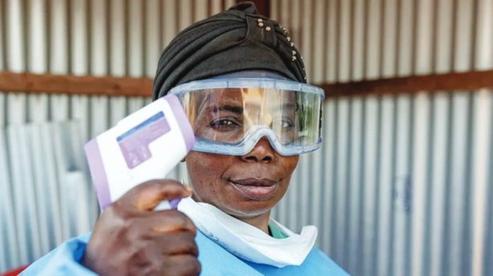 Congo A healthcare worker wears goggles and a mask pulled down from her mouth, and holds up a thermometer. Ebola has been confirmed in three provinces of Congo so far – Ituri, North Kivu and South Kivu. GETTY IMAGES