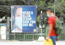 A banner reminding the public to wear face masks is installed at the busy corner of Quezon Avenue and Agham Road in Quezon City, in this file photo taken in 2021 at the height of the COVID-19 pandemic. NIÑO JESUS ORBETA, PHILIPPINE DAILY INQUIRER