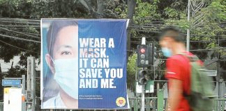 A banner reminding the public to wear face masks is installed at the busy corner of Quezon Avenue and Agham Road in Quezon City, in this file photo taken in 2021 at the height of the COVID-19 pandemic. NIÑO JESUS ORBETA, PHILIPPINE DAILY INQUIRER