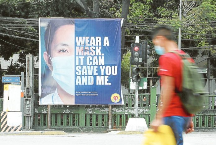 Covid A banner reminding the public to wear face masks is installed at the busy corner of Quezon Avenue and Agham Road in Quezon City, in this file photo taken in 2021 at the height of the COVID-19 pandemic. NIÑO JESUS ORBETA, PHILIPPINE DAILY INQUIRER