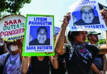 Protesters against Vice President Sara Duterte-Carpio carry posters bearing her photo during a rally near the Senate in Pasay City. AP