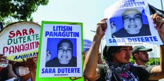Protesters against Vice President Sara Duterte-Carpio carry posters bearing her photo during a rally near the Senate in Pasay City. AP