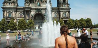 People cool off in the fountain in front of the Berlin Cathedral Berliner Dom during the ongoing heatwave. REUTERS