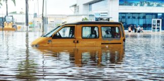 A yellow van is half-submerged in floodwater in the Ghanaian capital of Accra. EPA