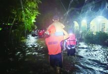 PCG saves 20 flood victims in Guimaras and Antique A Coast Guard rescuer carries a child through floodwaters as emergency responders escort displaced residents to safer ground in Hamtic, Antique. SN1 SURIAGA, PHILIPPINE COAST GUARD VIA HAZEL P. VILLA