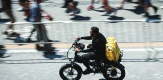 A food delivery rider cycles in Rome. Delivery riders are to strike in several Italian cities, calling for better working conditions in the intense summer heat. AFP VIA GETTY IMAGES