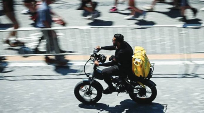 A food delivery rider cycles in Rome. Delivery riders are to strike in several Italian cities, calling for better working conditions in the intense summer heat. AFP VIA GETTY IMAGES