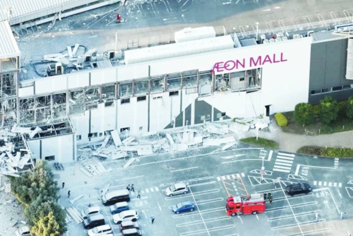 This is a birds-eye view of the quake-hit Aeon Mall with broken windows and debris in the carpark. The second floor of the mall collapsed, leaving many people trapped inside. REUTERS