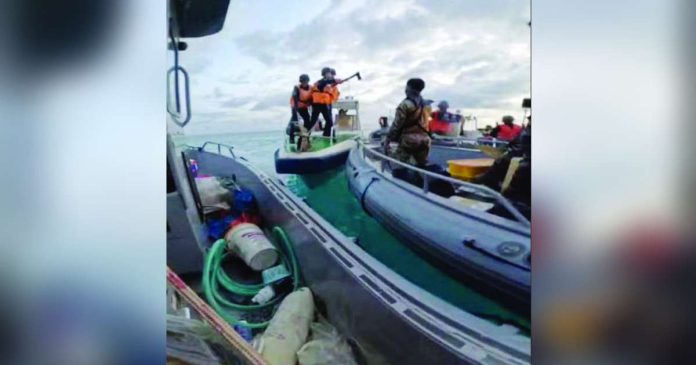 PBBM arbitral copy_superimposed A China Coast Guard personnel was caught on camera by the Armed Forces of the Philippines threatening to injure a Filipino soldier with a pickaxe during the Philippines’ humanitarian rotation and resupply mission at BRP Sierra Madre in Ayungin Shoal on June 17, 2024. China does not recognize the July 12, 2016 ruling by the Permanent Court of Arbitration, which declared that China had violated the Philippines' sovereign rights within its exclusive economic zone by interfering with fishing and petroleum exploration activities, constructing artificial islands, and failing to prevent Chinese nationals from fishing in Philippine waters.