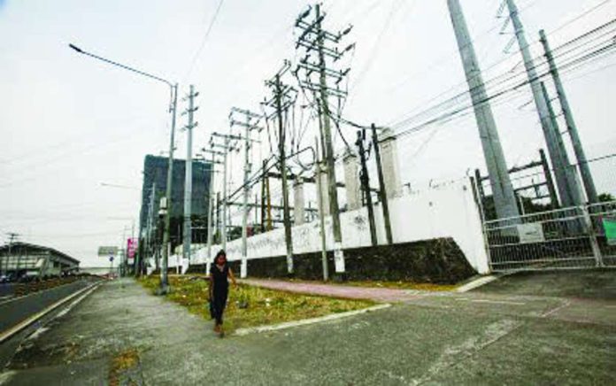 PH_power_rates_compressed_resized The Luzon and Visayas power grids returned to normal operations after red aThe Department of Energy attributes last June’s jump in power rates to the tight power situation in the Visayas, which was put under numerous yellow alerts, with some days even witnessing red alerts. Photo shows the Manila Electric Co. substation along Commonwealth Avenue in Diliman, Quezon City. PNA PHOTO BY JOAN BONDOC