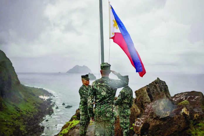 Filipino soldiers take part in a flag raising ceremony in Mavulis Island, Batanes, in this photo take on June 29, 2023. Chinese academics claim Batanes belongs to China through Taiwan. FILE PHOTO/AGENCE FRANCE-PRESSE