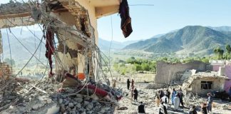 People inspect a damaged house at the site of Pakistani airstrikes in Mandokhail village in Paktia province, Afghanistan. REUTERS