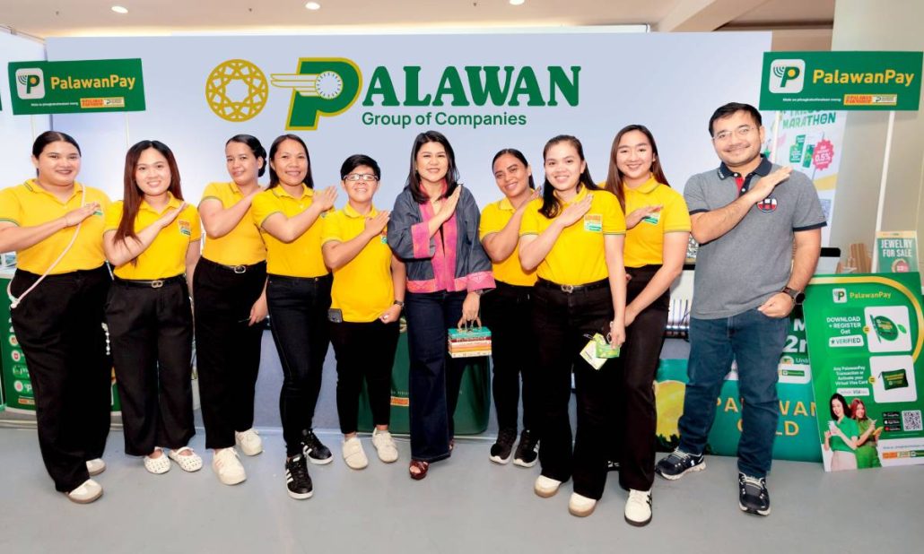 Lilian Castro-Selda (center), Vice Chairman and Chief Financial Officer of the Palawan Group of Companies, and Bernard Kaibigan (right), Chief Marketing Officer, with the Palawan team supporting booth operations and showcasing the company's accessible digital and financial solutions.
