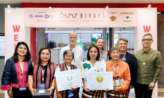 PalawanPay Unlocks New Financial Opportunities for Filipino MSMEs at BIYAYA 2026 From left, Lilian Castro-Selda, Chief Financial Officer of the Palawan Group of Companies, and (2nd from right) Rich Watanabe, Founder of the Coffee Heritage Project and BIYAYA Festival, together with partners, distinguished guests, and local coffee farmers recognized as awardees of the AVPA (Agency for the Valorization of Agricultural Products) during the opening of the BIYAYA Sustainable Living Festival 2026.