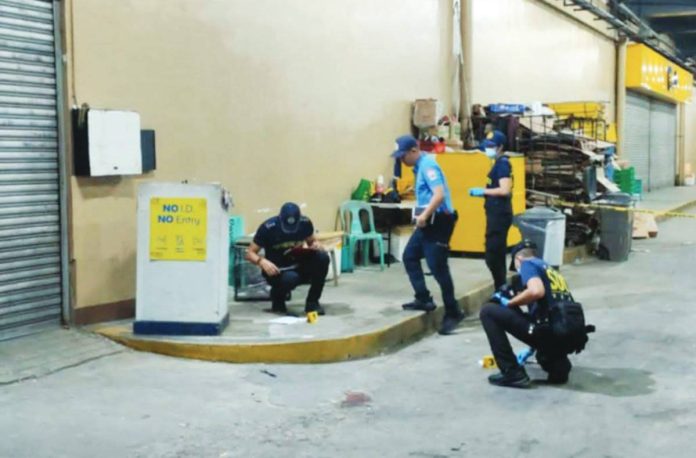Pavia shooting Police investigators process the scene at the storage area of GT Town Mall in Barangay Ungka II, Pavia, Iloilo, on Friday, July 31, 2026. A security guard stationed at the mall shot one of two suspects in self-defense after being assaulted and threatened.